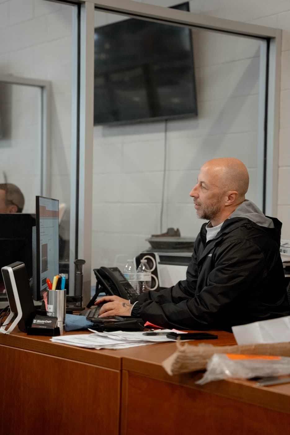 Service advisor handling paperwork at the shop desk